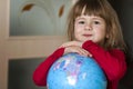 Portrait of the cute little girl hugging the earth globe. Education and save the earth concept. Pretty child looking in the camera Royalty Free Stock Photo