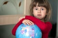 Portrait of the cute little girl hugging the earth globe. Education and save the earth concept. Pretty child looking in the camera Royalty Free Stock Photo