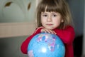 Portrait of the cute little girl hugging the earth globe. Education and save the earth concept. Pretty child looking in the camera Royalty Free Stock Photo