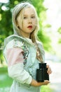 Cute little girl with a retro binoculars in a city park Royalty Free Stock Photo