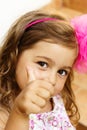 Portrait of cute little girl showing thumbs up Royalty Free Stock Photo