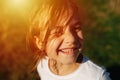 Portrait of a cute little girl, squinting under an orange sunlight Royalty Free Stock Photo