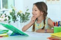 Portrait of cute little girl studying at home