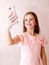 Portrait of cute little girl taking a selfie isolated Royalty Free Stock Photo