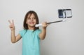 Portrait cute little girl taking a selfie over white background Royalty Free Stock Photo