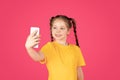 Portrait Of Cute Little Girl Taking Selfie On Smartphone Royalty Free Stock Photo