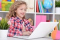 Portrait of cute little girl using modern laptop Royalty Free Stock Photo