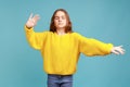 Portrait of cute little girl walking blind with closed eyes and outstretched hands, searching way.