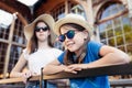 Portrait of a cute little girl wearing hat and sunglasses with her sister Royalty Free Stock Photo