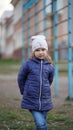 Portrait of cute little girl in white hat on playground near swedish ladder