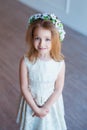 Portrait of a cute little girl in wreath of flowers Royalty Free Stock Photo