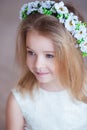 Portrait of a cute little girl in wreath of flowers Royalty Free Stock Photo