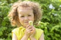 Portrait of cute little girl with yellow chicken on hands on green grass outdoors. happy easter kids concept Royalty Free Stock Photo