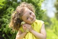 Portrait of cute little girl with yellow chicken on hands on green grass outdoors. happy easter kids concept. Royalty Free Stock Photo