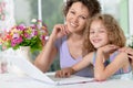 Cute little girl with young mother using laptop Royalty Free Stock Photo