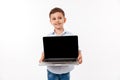 Portrait of a cute little kid showing blank screen laptop Royalty Free Stock Photo