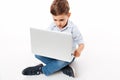 Portrait of a cute little kid using laptop computer Royalty Free Stock Photo