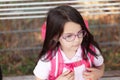 Portrait of a cute little schoolgirl with pink backpack and glasses Royalty Free Stock Photo