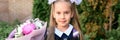 Portrait of a cute little seven year old first-grader girl with a bouquet of flowers ready to go to school. back to school concept Royalty Free Stock Photo