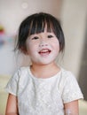 Portrait of cute little smile girl with baby powder on her face. Talcum concept Royalty Free Stock Photo