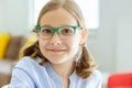 Portrait of cute little teen girl in glasses with funny pigtails smiling Royalty Free Stock Photo