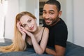 Portrait cute lovely couple in love chilling, smiling to camera on bed in modern apartment. Joy, expressing true Royalty Free Stock Photo