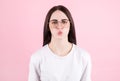 Portrait of cute lovely girl in casual outfit blowing kiss with pout lips looking at camera isolated on pink background