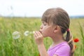 Portrait of cute lovely little girl blowing soap bubbles Royalty Free Stock Photo
