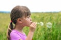 Portrait of cute lovely little girl blowing soap bubbles Royalty Free Stock Photo