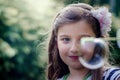 Portrait of cute lovely little girl blowing soap bubbles. Royalty Free Stock Photo