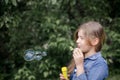 Portrait of cute lovely little girl blowing soap bubbles. Royalty Free Stock Photo