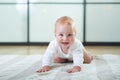 Portrait of a cute 6 months baby boy crawling on the floor Royalty Free Stock Photo