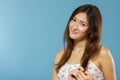 Portrait of cute morning girl. Beautiful cheerful teen girl looking at camera over blue background. Young woman posing in pajamas