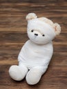 Portrait of cute mummy teddy bear doll bind with white gauze or bandage on dark wooden background Royalty Free Stock Photo