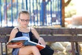 Summer Time Relaxing - Little Girl Reading Book Outdoor On Warm Day. Royalty Free Stock Photo