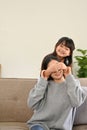 Portrait, Cute and playful young Asian girl surprising or playing peek a boo with her mom Royalty Free Stock Photo
