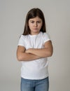Pretty little girl with angry facial expression looking mad at the camera. Human emotions Royalty Free Stock Photo