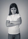 Pretty little girl with angry facial expression looking mad at the camera. Human emotions Royalty Free Stock Photo