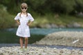 Portrait of cute pretty funny young girl with blond braids in white dress and dark sunglasses. Royalty Free Stock Photo