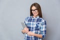 Portrait of cute pretty young woman in glasses holding tablet Royalty Free Stock Photo