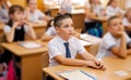 Portrait of cute primary schoolboy on the lesson. Kids writing test Royalty Free Stock Photo