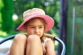 Portrait of cute sad little girl at big hat  looking sad at summer day Royalty Free Stock Photo