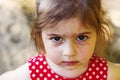 Portrait of cute sad little girl looking at camera at summer day Royalty Free Stock Photo