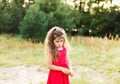 Portrait of cute sad little girl looking worried at summer day