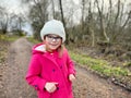 Portrait of a cute school girl with eyeglasses outdoors in park. Happy funny child on autumn, spring or winter day. Royalty Free Stock Photo