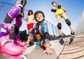 Cute boy in roller skates having fun with friends Royalty Free Stock Photo