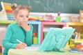 Portrait of a cute schoolgirl doing homework