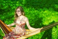 Portrait of Cute And Sensual Caucasian Blond Girl Relaxing In Hammock In Green Forest Outdoors Royalty Free Stock Photo