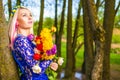 Portrait of Cute and Sensual Romantic Caucasian Blond Girl with Bunch of Tulips Posing Outdoors Royalty Free Stock Photo