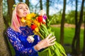 Portrait of Cute and Sensual Romantic Caucasian Blond Girl with Bunch of Tulips Posing Outdoors Royalty Free Stock Photo